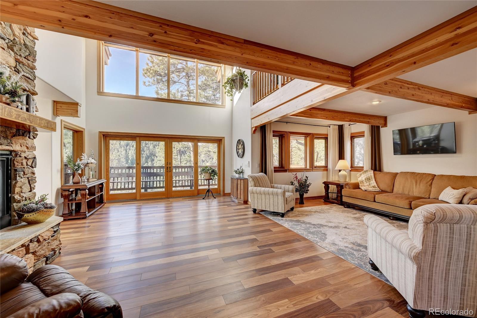 27164 Sun Ridge Drive Evergreen, CO 80439 - Photo 13 of 40 a living room with furniture and a large window