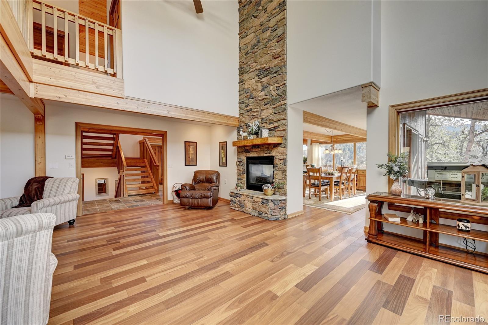 27164 Sun Ridge Drive Evergreen, CO 80439 - Photo 14 of 40 a view of living room kitchen with furniture and wooden floor