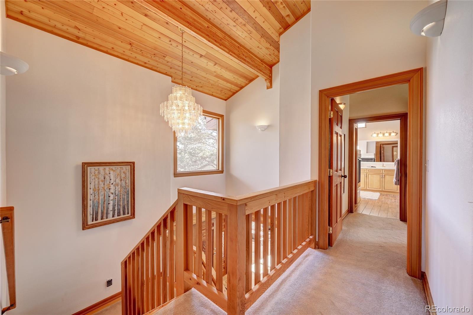 27164 Sun Ridge Drive Evergreen, CO 80439 - Photo 18 of 40 a view of a hallway with windows