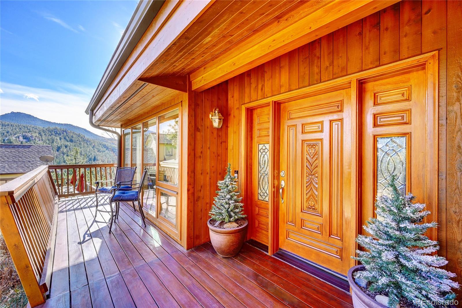 27164 Sun Ridge Drive Evergreen, CO 80439 - Photo 2 of 40 a view of a balcony with chair and potted plants