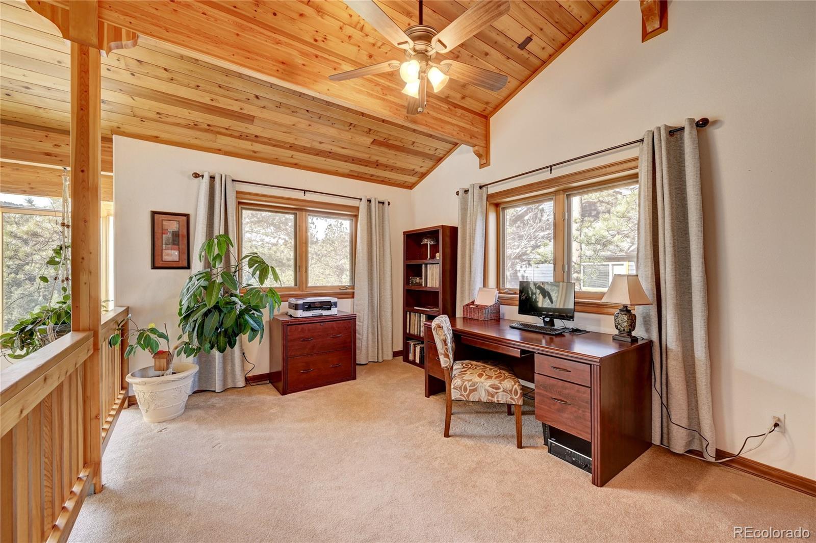 27164 Sun Ridge Drive Evergreen, CO 80439 - Photo 24 of 40 a living room with furniture and a large window