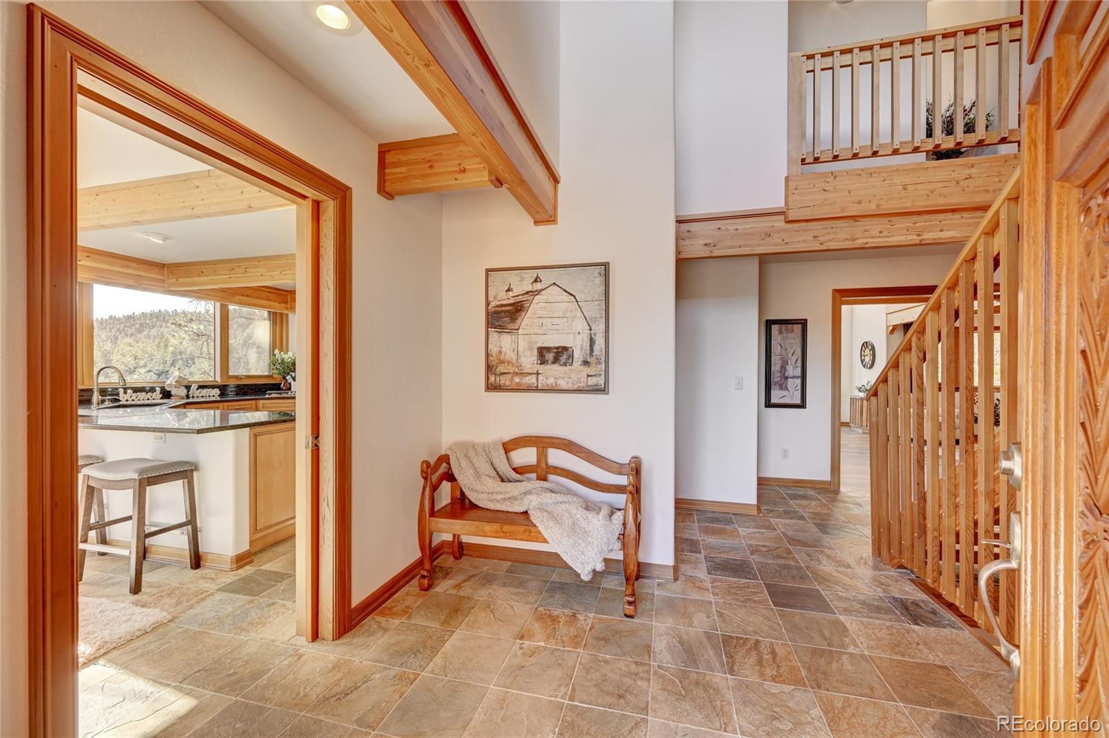 27164 Sun Ridge Drive Evergreen, CO 80439 - Photo 3 of 40 a view of a hallway with seating area