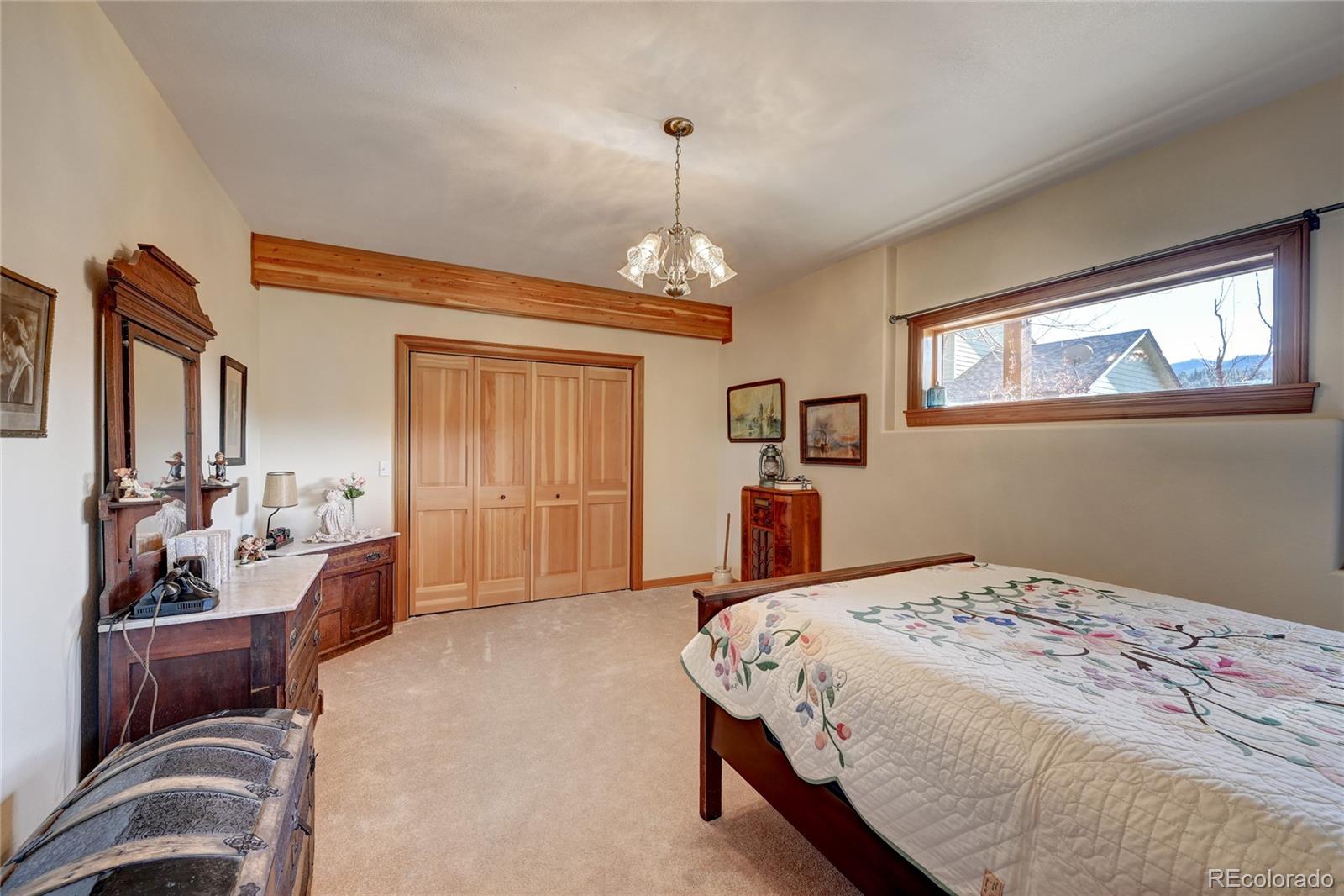 27164 Sun Ridge Drive Evergreen, CO 80439 - Photo 32 of 40 a bedroom with a bed and a window