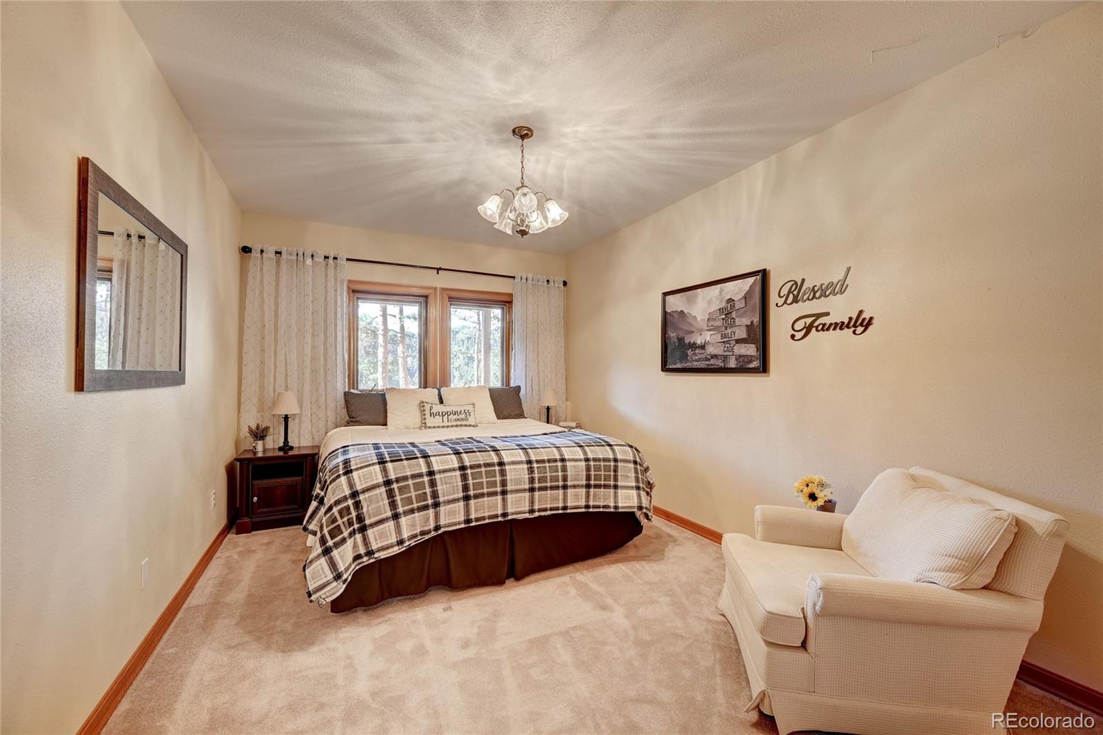 27164 Sun Ridge Drive Evergreen, CO 80439 - Photo 34 of 40 a bedroom with a bed couch and window