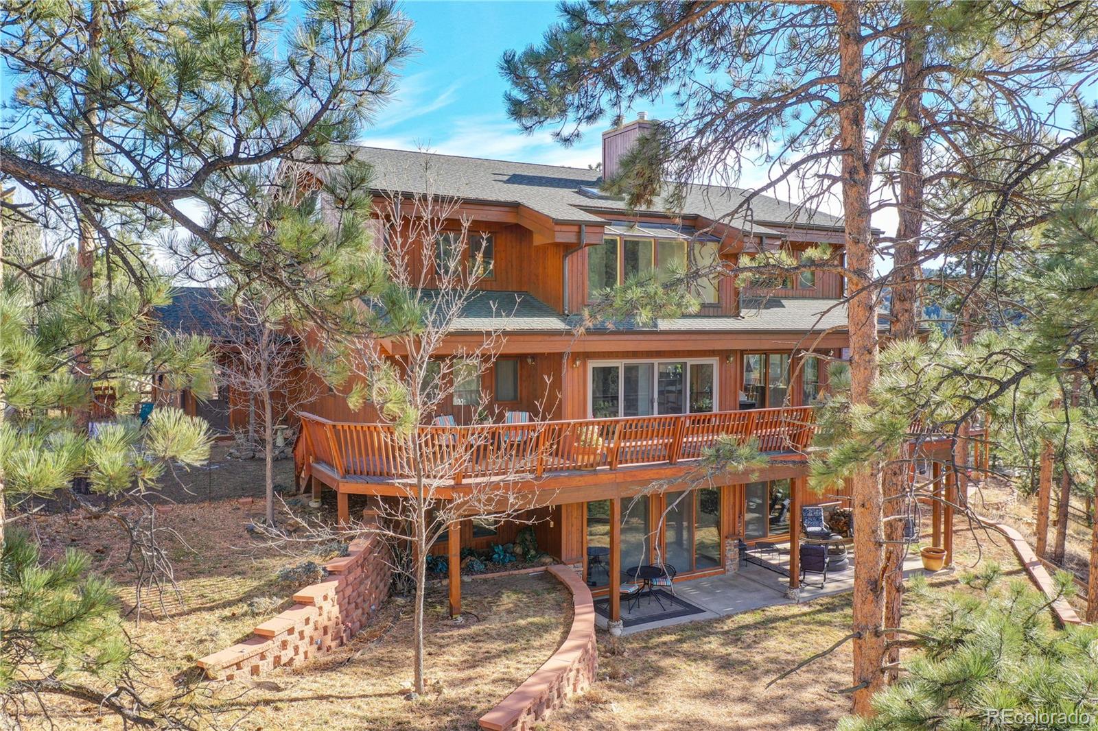 27164 Sun Ridge Drive Evergreen, CO 80439 - Photo 39 of 40 a view of a house with a yard and sitting area