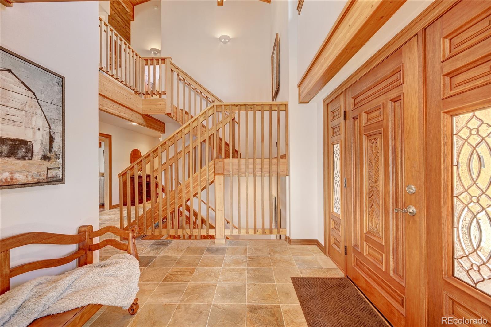 27164 Sun Ridge Drive Evergreen, CO 80439 - Photo 4 of 40 a view of staircase with railing and a rug