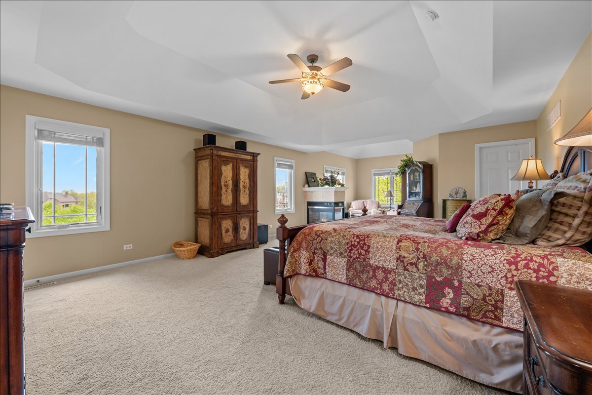 430 Alberosky Way Batavia, IL 60510 - Photo 22 of 49 a spacious bedroom with a large bed and a chandelier