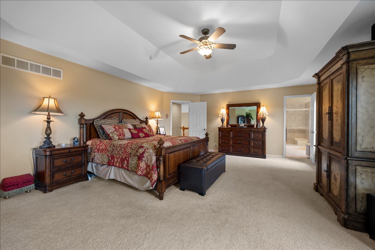 430 Alberosky Way Batavia, IL 60510 - Photo 24 of 49 a bedroom with a bed and a chandelier