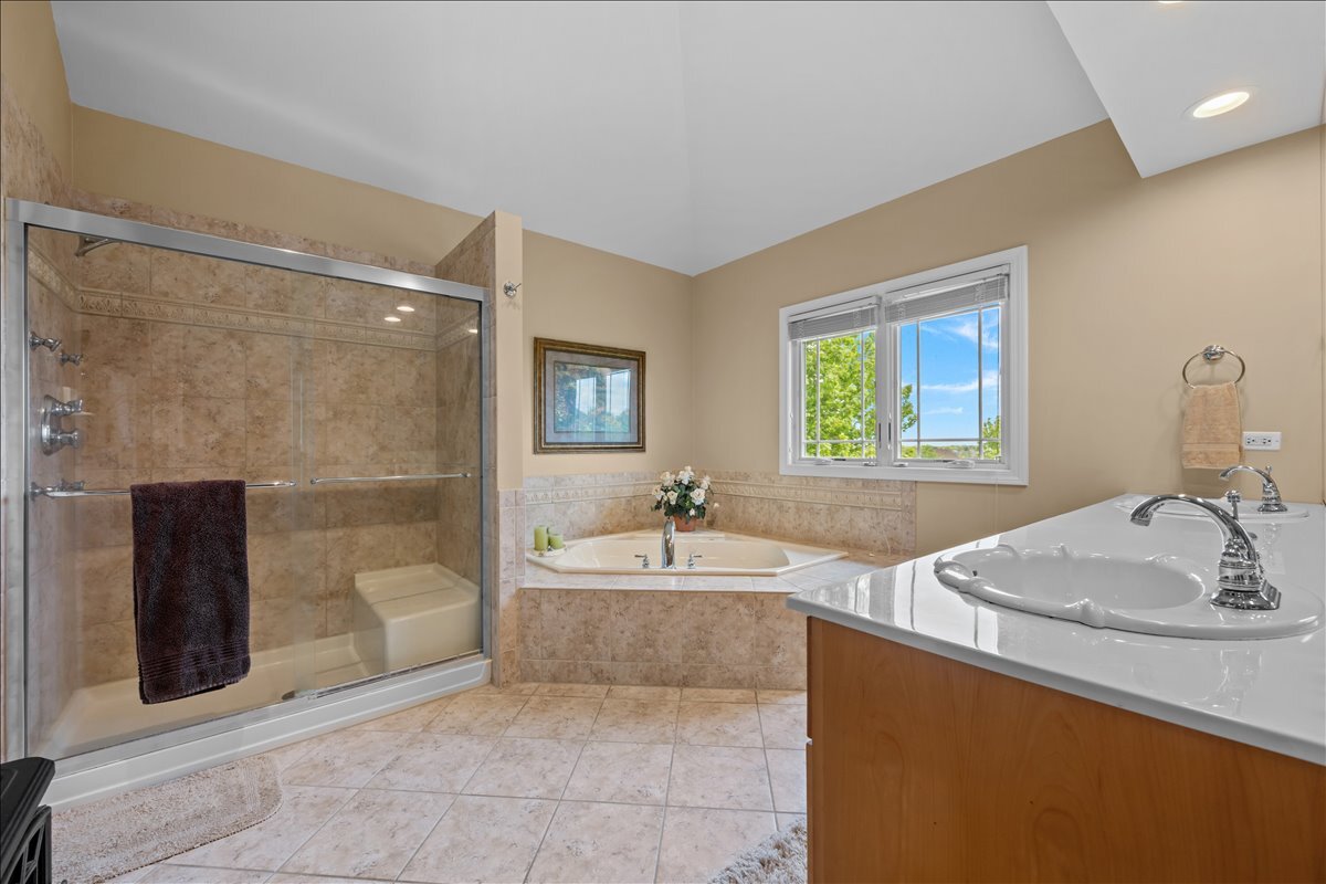 430 Alberosky Way Batavia, IL 60510 - Photo 25 of 49 a bathroom with a sink a bathtub a mirror and a shower
