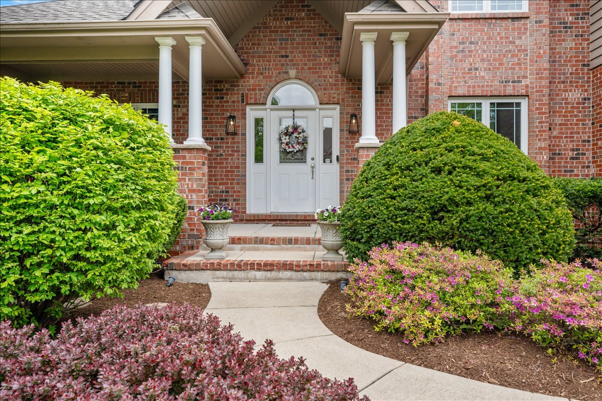 430 Alberosky Way Batavia, IL 60510 - Photo 3 of 49 a front view of a house with a yard and flowers