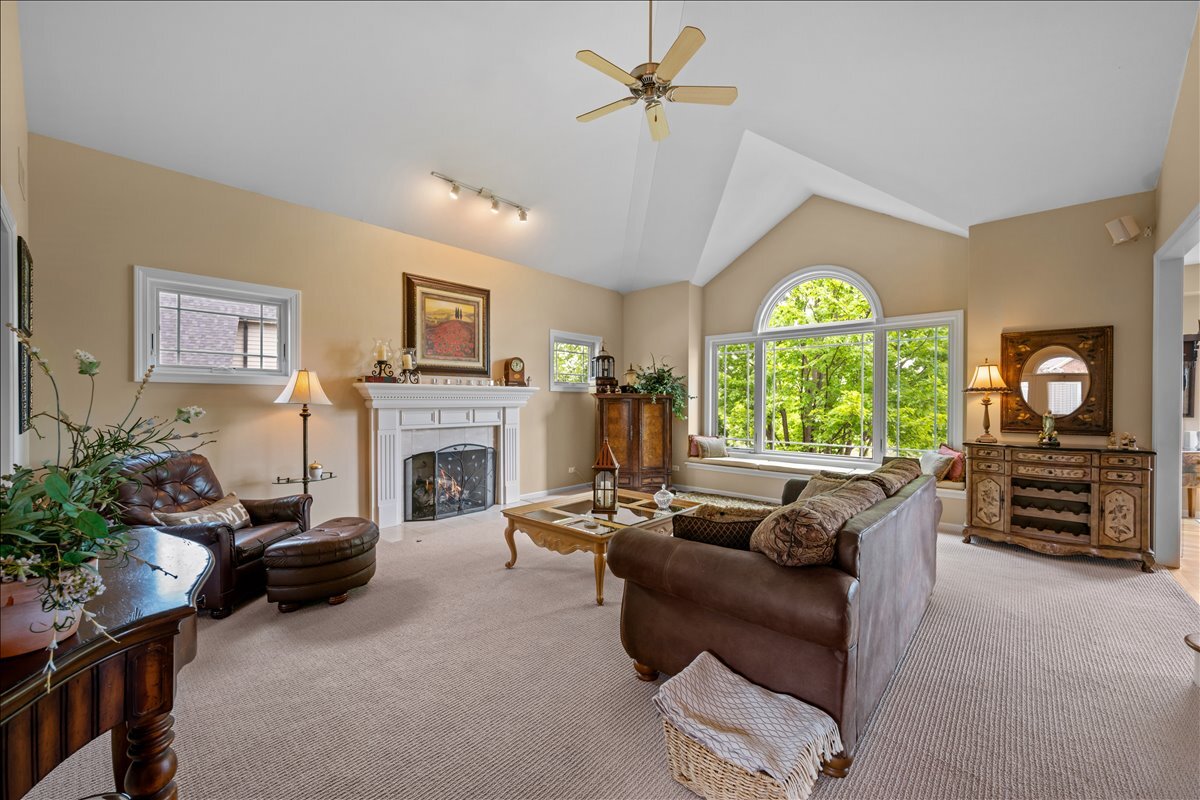 430 Alberosky Way Batavia, IL 60510 - Photo 9 of 49 a living room with furniture a fireplace and a flat screen tv