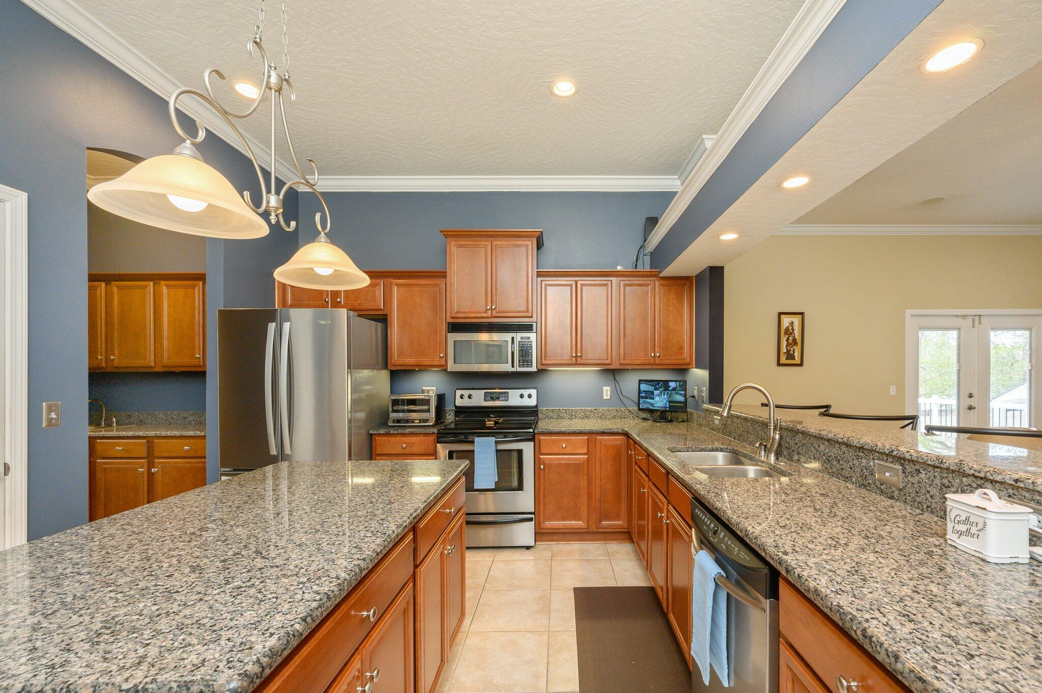 203 Eleases Crossing Crestview, FL 32539 - Photo 12 of 43 a kitchen with stainless steel appliances granite countertop a sink stove and refrigerator
