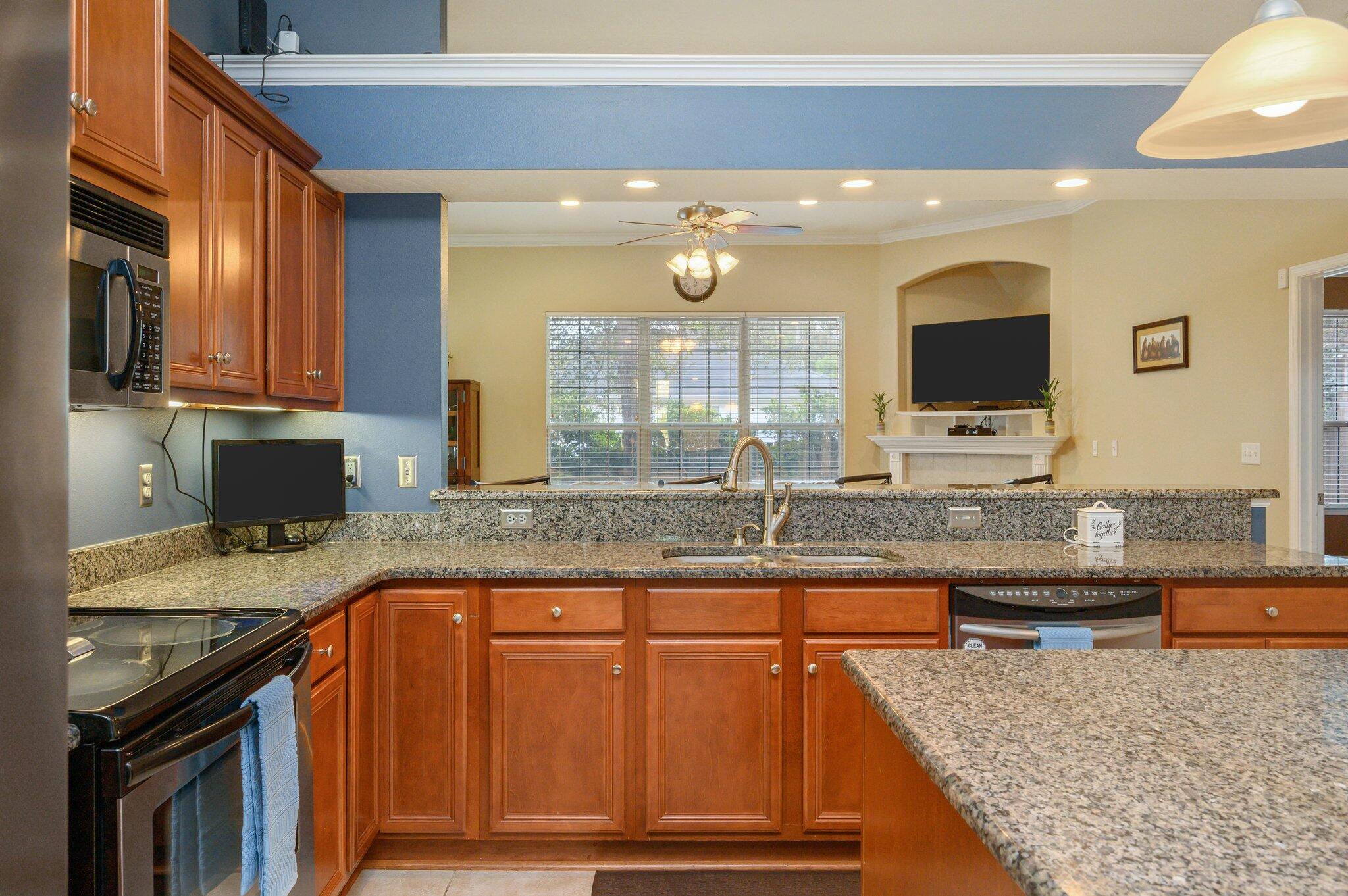 203 Eleases Crossing Crestview, FL 32539 - Photo 14 of 43 a kitchen with granite countertop a sink and a stove