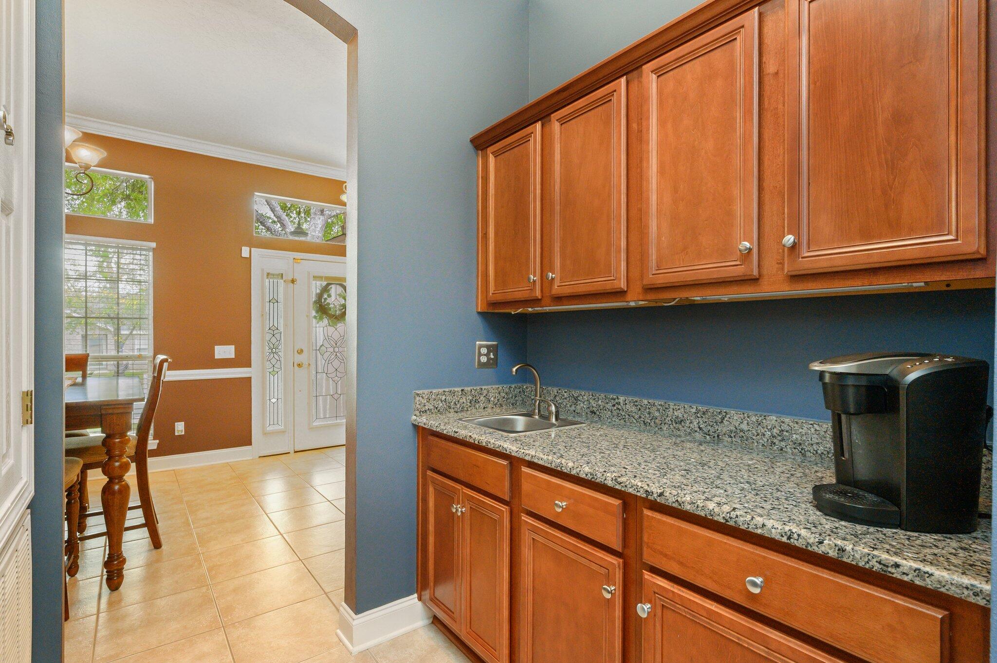203 Eleases Crossing Crestview, FL 32539 - Photo 15 of 43 a kitchen with granite countertop wooden cabinets a sink and dishwasher
