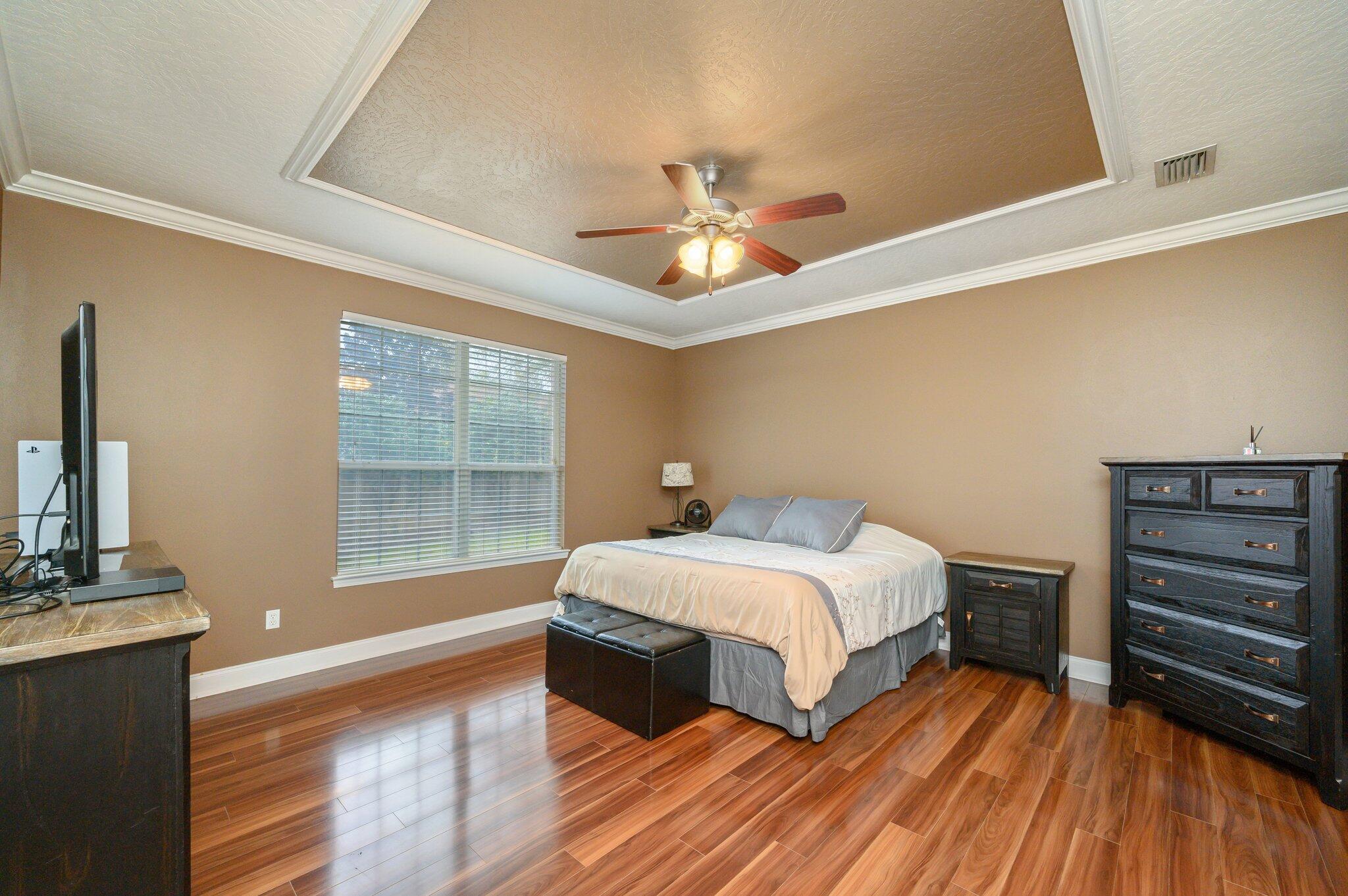 203 Eleases Crossing Crestview, FL 32539 - Photo 16 of 43 a bedroom with a bed and wooden floor