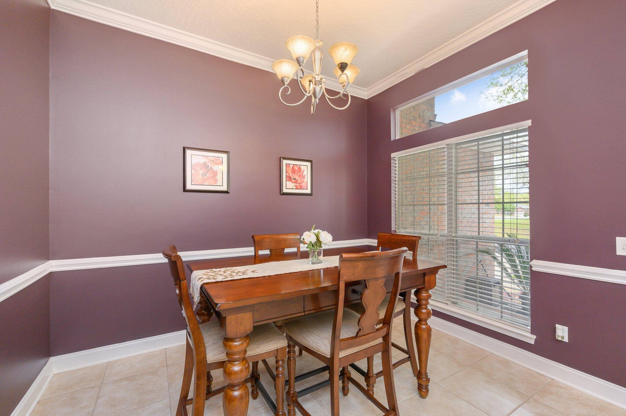 203 Eleases Crossing Crestview, FL 32539 - Photo 4 of 43 a view of a dining room with furniture wooden floor and chandelier