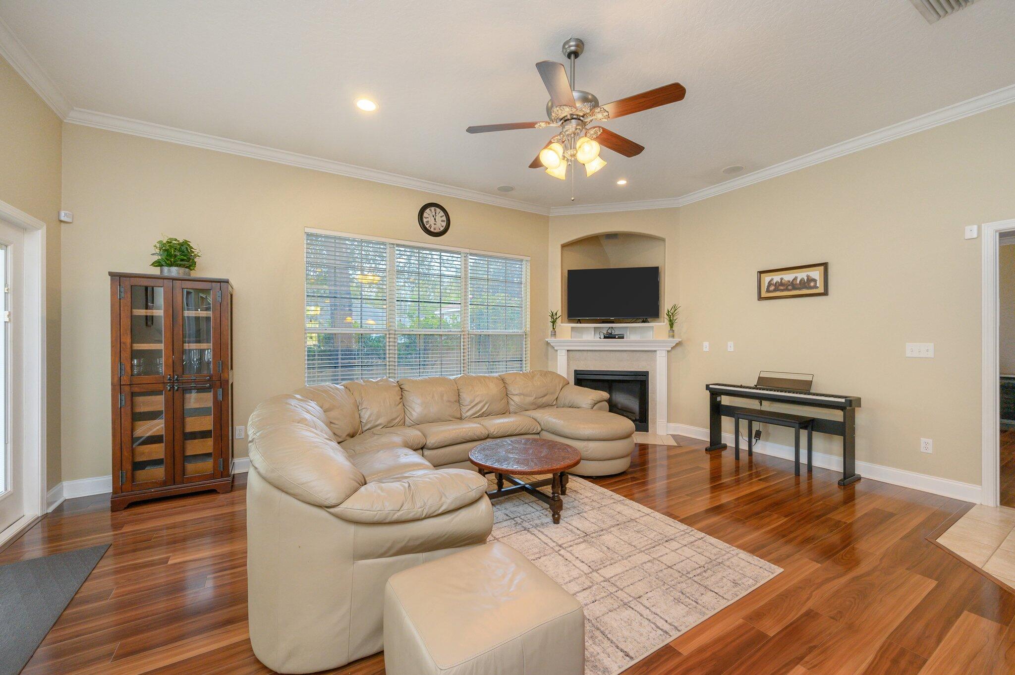 203 Eleases Crossing Crestview, FL 32539 - Photo 6 of 43 a living room with furniture a fireplace and a flat screen tv