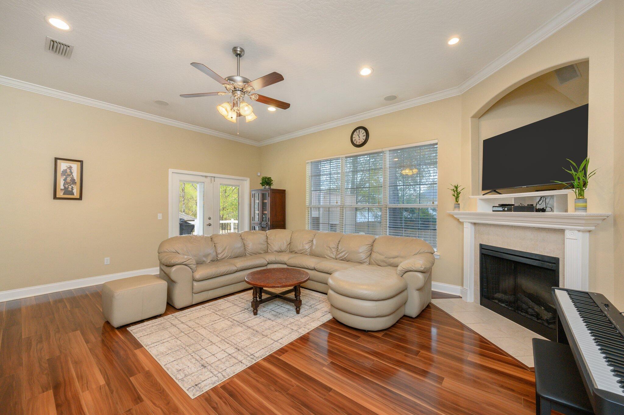 203 Eleases Crossing Crestview, FL 32539 - Photo 7 of 43 a living room with furniture a fireplace and a flat screen tv