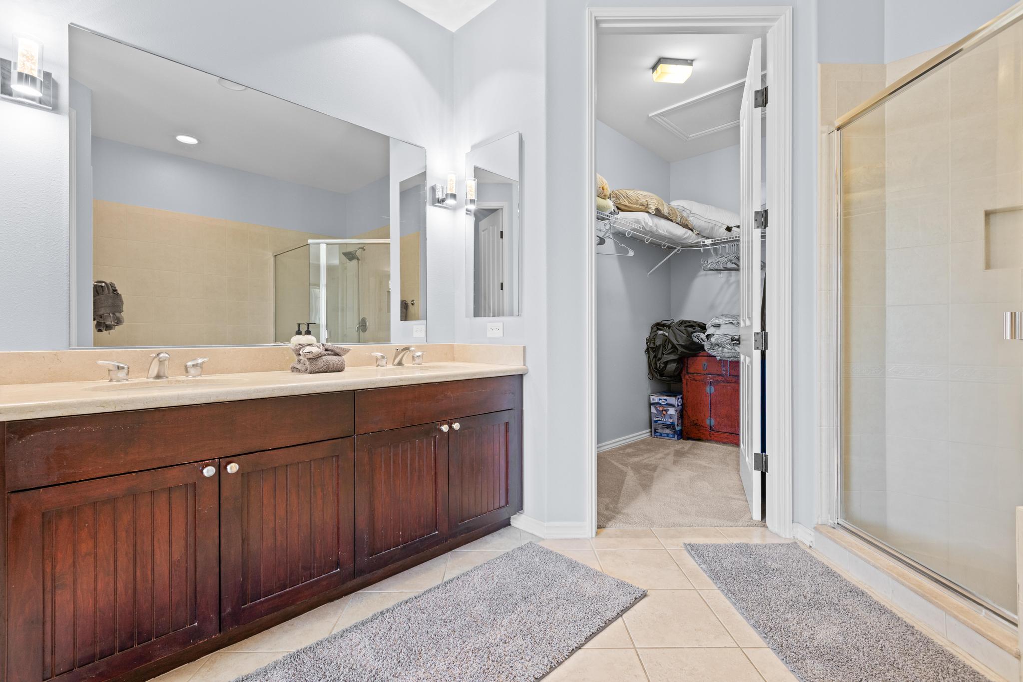 69-200 Pohakulana Place, Unit C4 Waikoloa, HI 96738 - Photo 15 of 30 a spacious bathroom with a double vanity sink a mirror and a shower