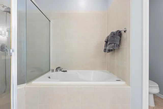 a white bath tub sitting next to a white sink