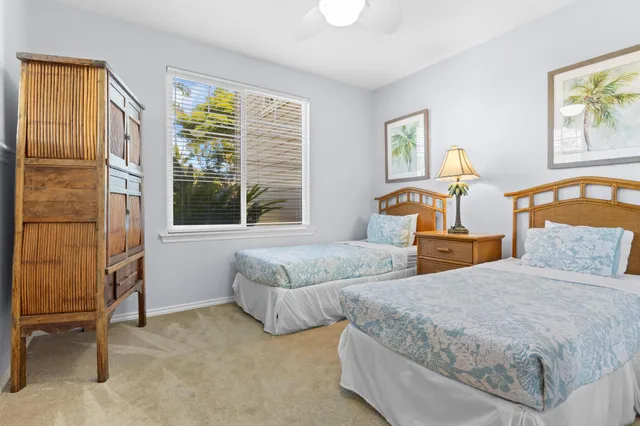 a bedroom with two beds and a window