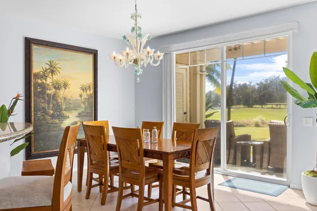a view of a dining room with furniture large windows and wooden floor