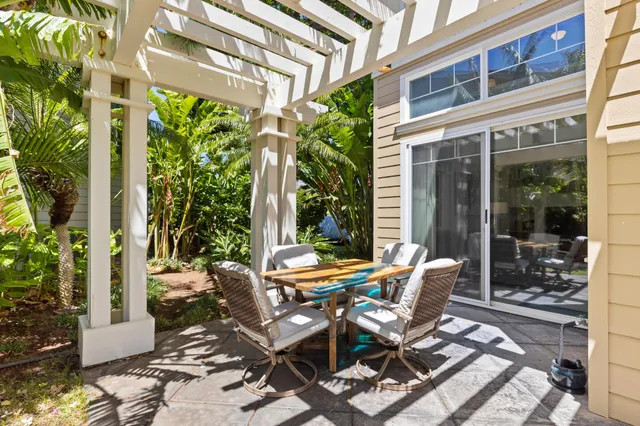 a view of a patio with table and chairs and potted plants