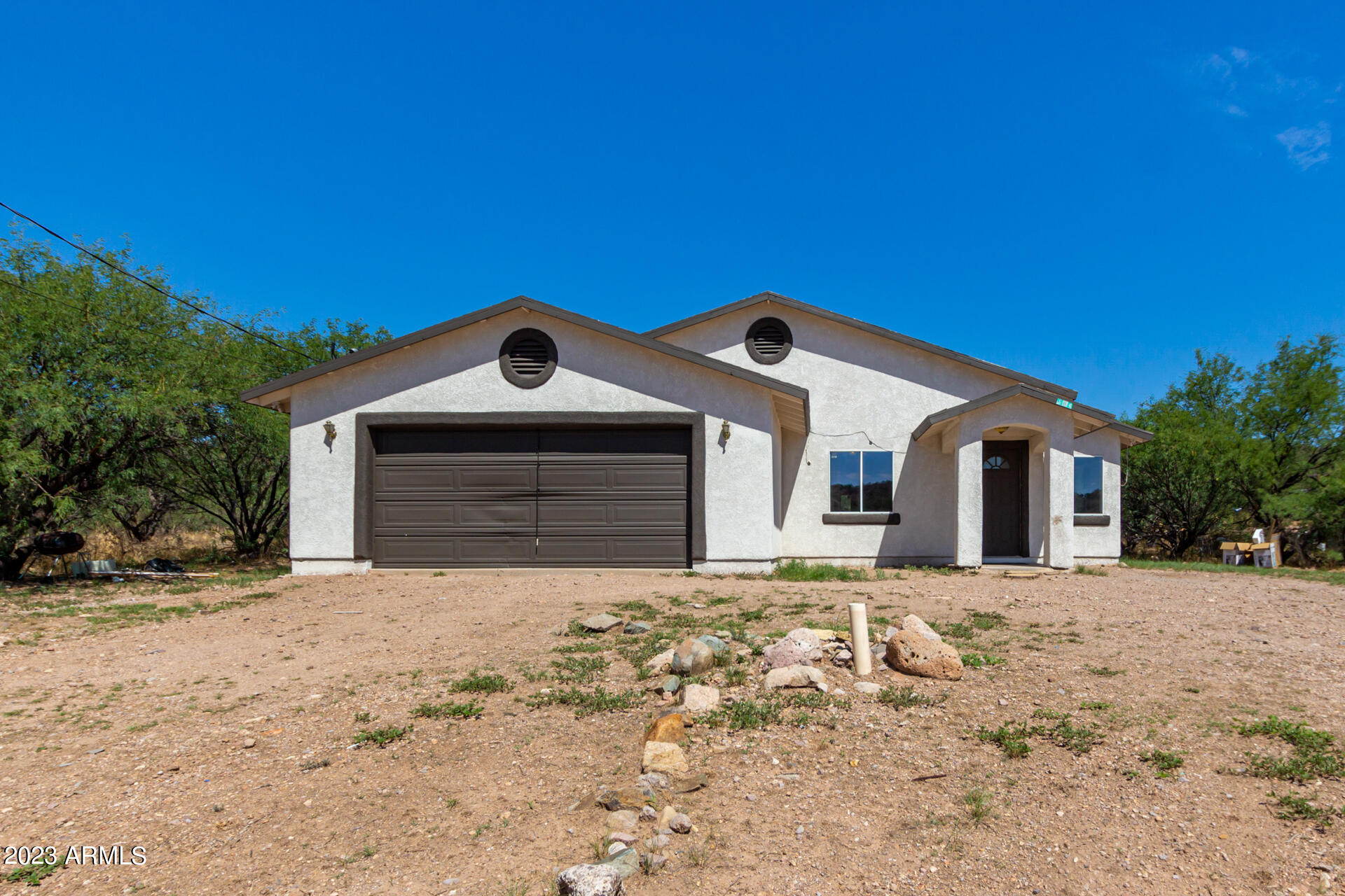 584 Ruben Court Rio Rico, AZ 85648 - Photo 1 of 12 a front view of a house with a yard