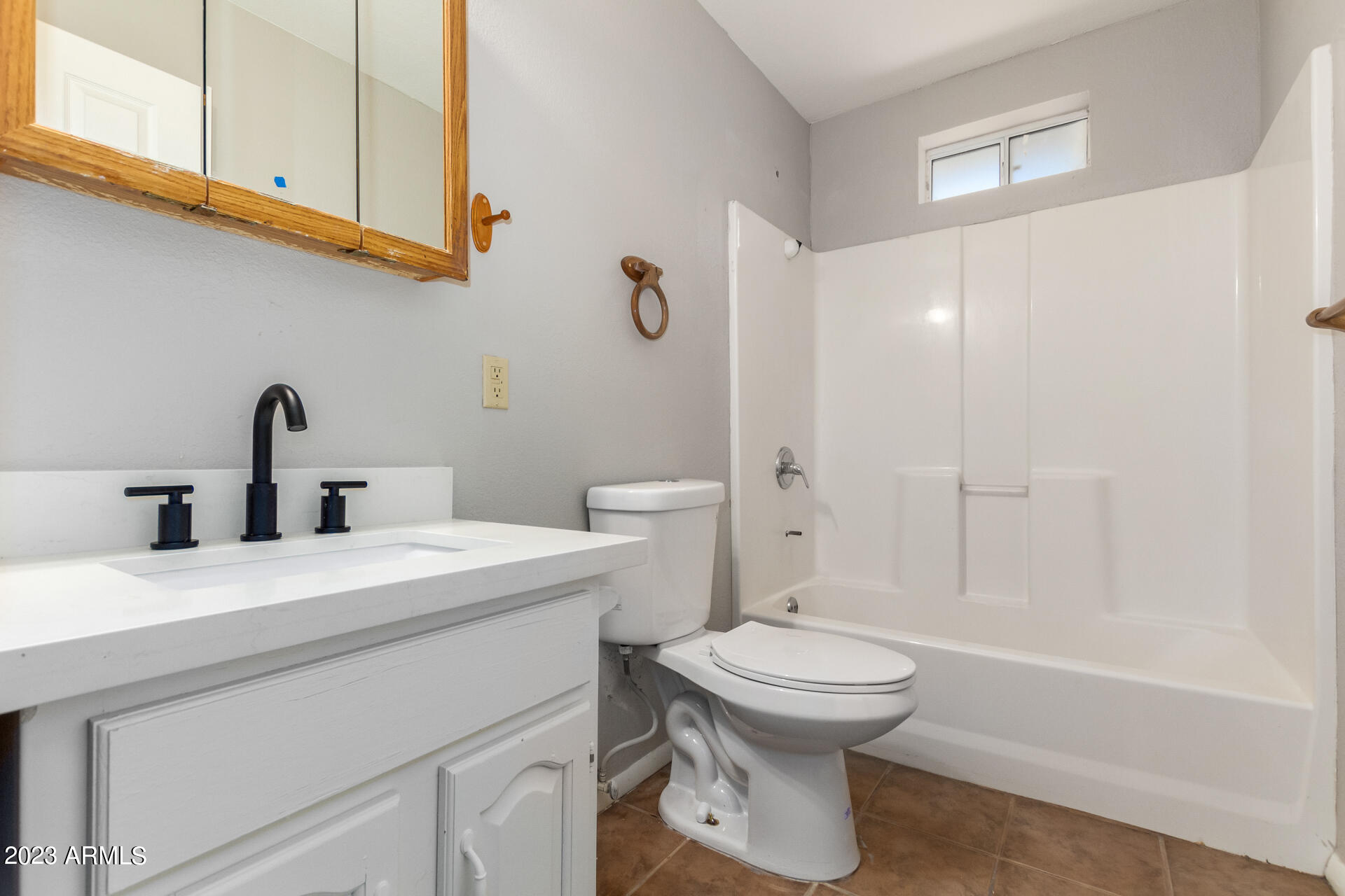 584 Ruben Court Rio Rico, AZ 85648 - Photo 11 of 12 a bathroom with a sink a toilet and shower