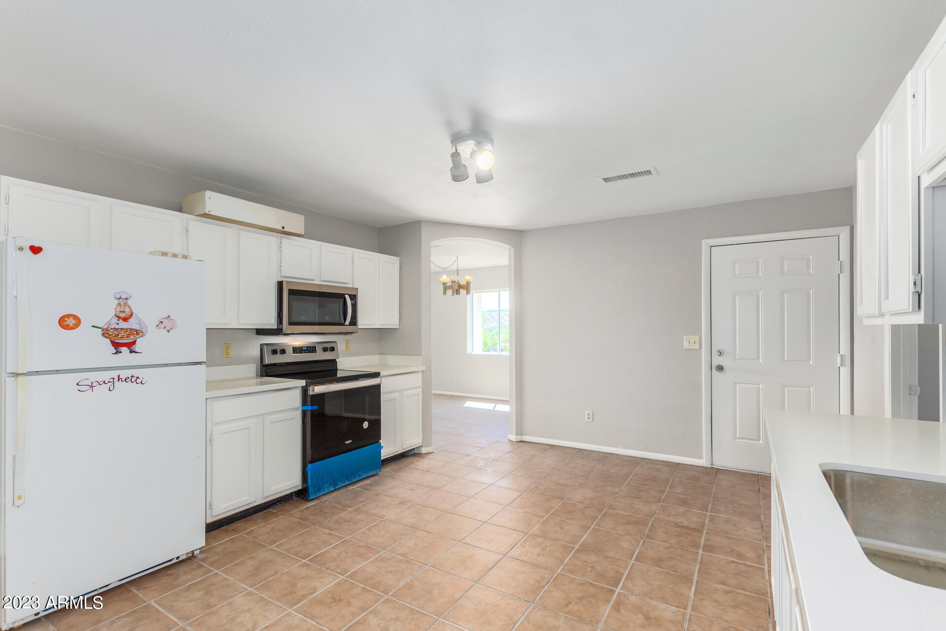 584 Ruben Court Rio Rico, AZ 85648 - Photo 5 of 12 a kitchen with a sink stainless steel appliances and white cabinets