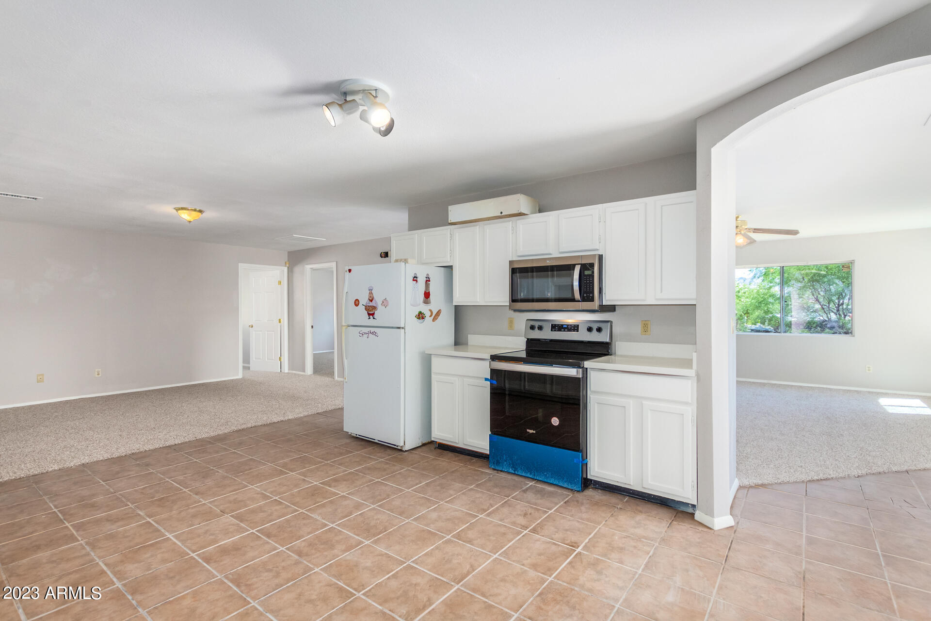584 Ruben Court Rio Rico, AZ 85648 - Photo 7 of 12 a kitchen with stainless steel appliances a refrigerator sink and microwave
