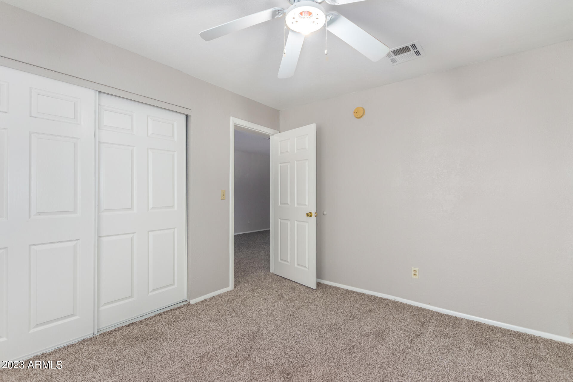 584 Ruben Court Rio Rico, AZ 85648 - Photo 10 of 12 an empty room with a ceiling fan