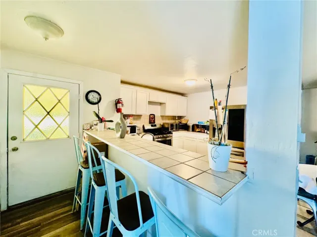 a kitchen with white cabinets and appliances