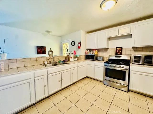 a kitchen with stainless steel appliances kitchen island granite countertop a sink and cabinets
