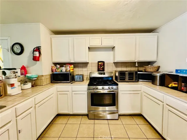 a kitchen with stainless steel appliances a stove a sink and a refrigerator
