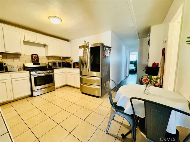 a kitchen with stainless steel appliances kitchen island granite countertop a refrigerator and cabinets