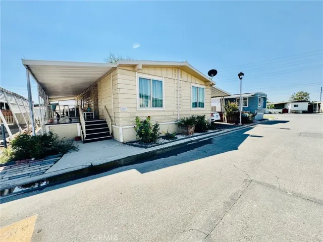 a front view of a house with plants