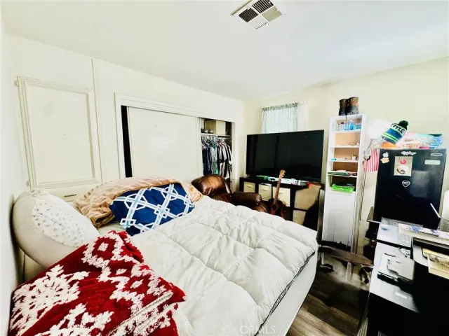 a bedroom with a bed and a mirror