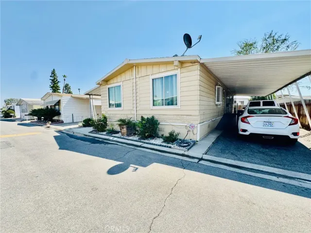 a view of a car park in front of a house