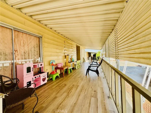 a view of backyard with swimming pool and furniture