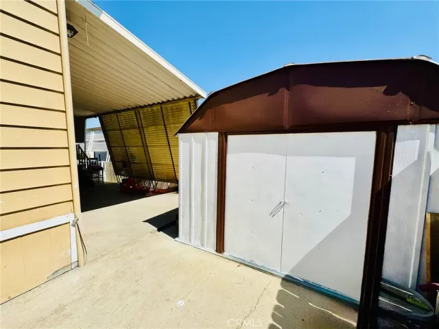 a backyard of a house with table and chairs