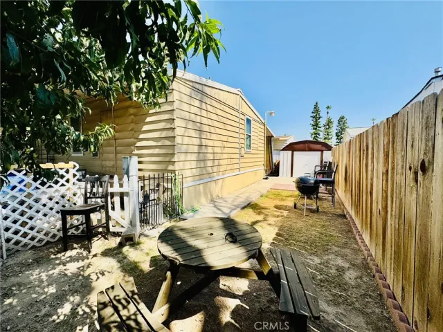 a view of a chairs and table in backyard