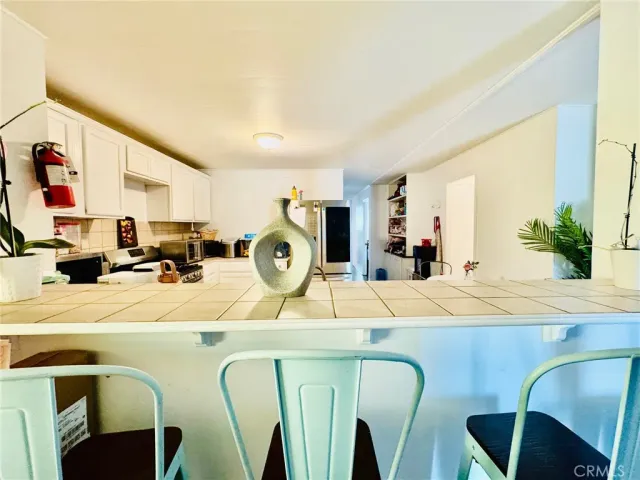 a view of a kitchen with kitchen island a counter top space a sink and appliances