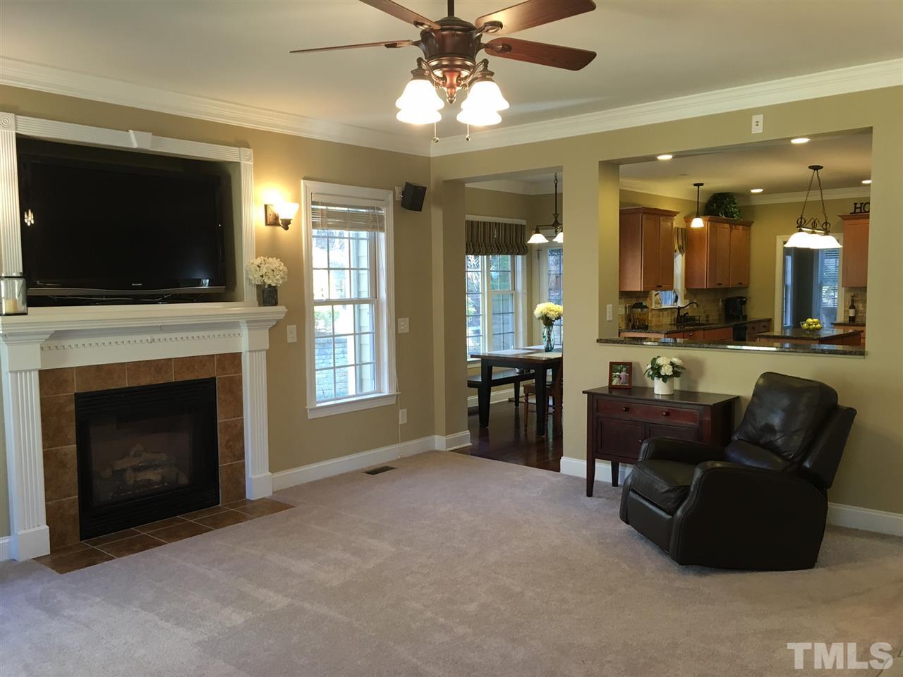 8114 Dreamy Way Raleigh, NC 27613 - Photo 11 of 22 a living room with furniture a flat screen tv and a fireplace