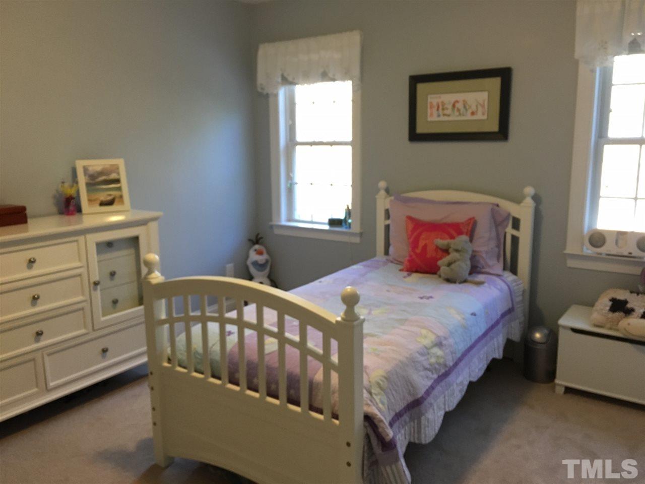 8114 Dreamy Way Raleigh, NC 27613 - Photo 14 of 22 a bedroom with a bed and a window