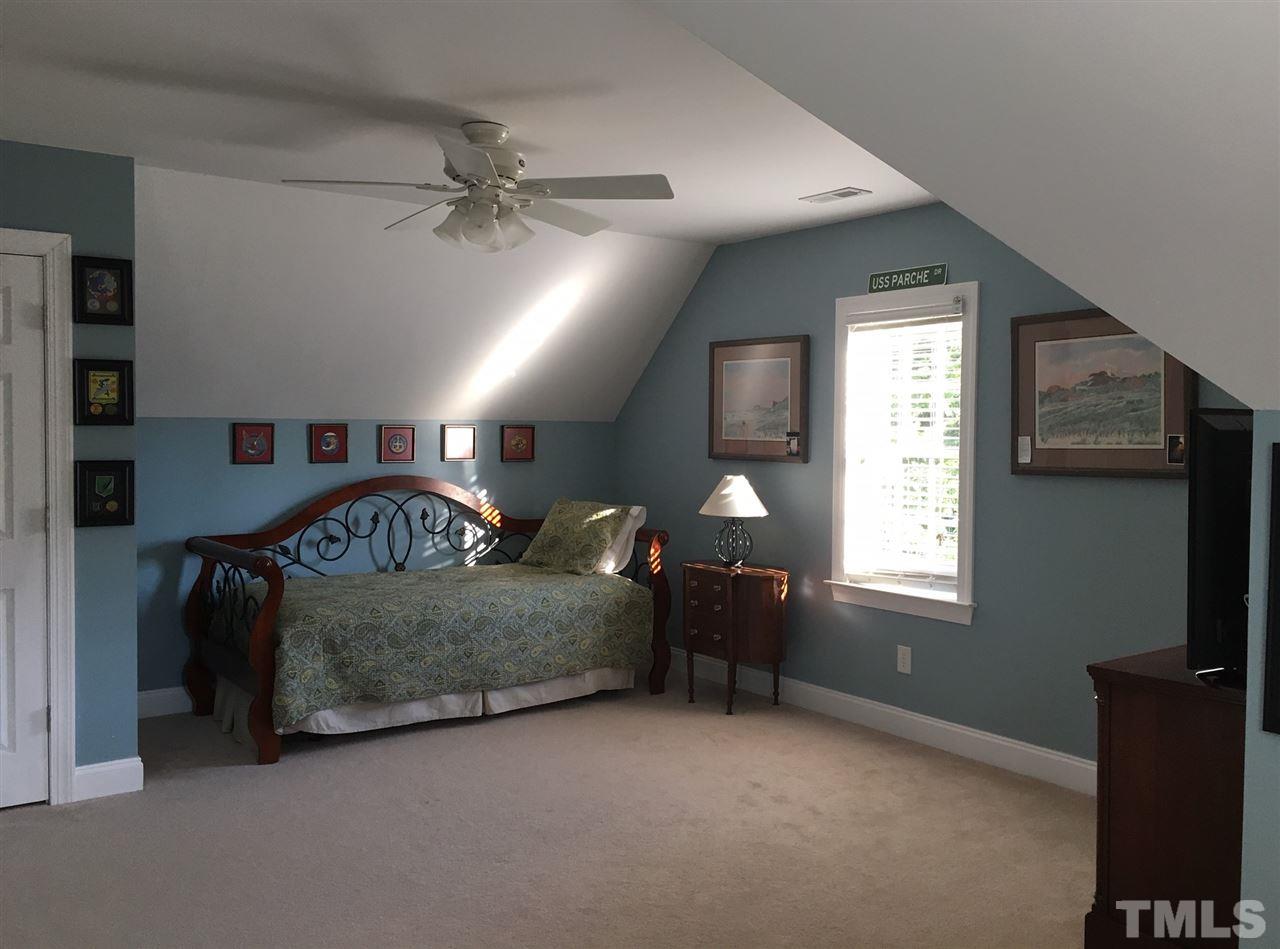 8114 Dreamy Way Raleigh, NC 27613 - Photo 16 of 22 a living room with furniture and a flat screen tv