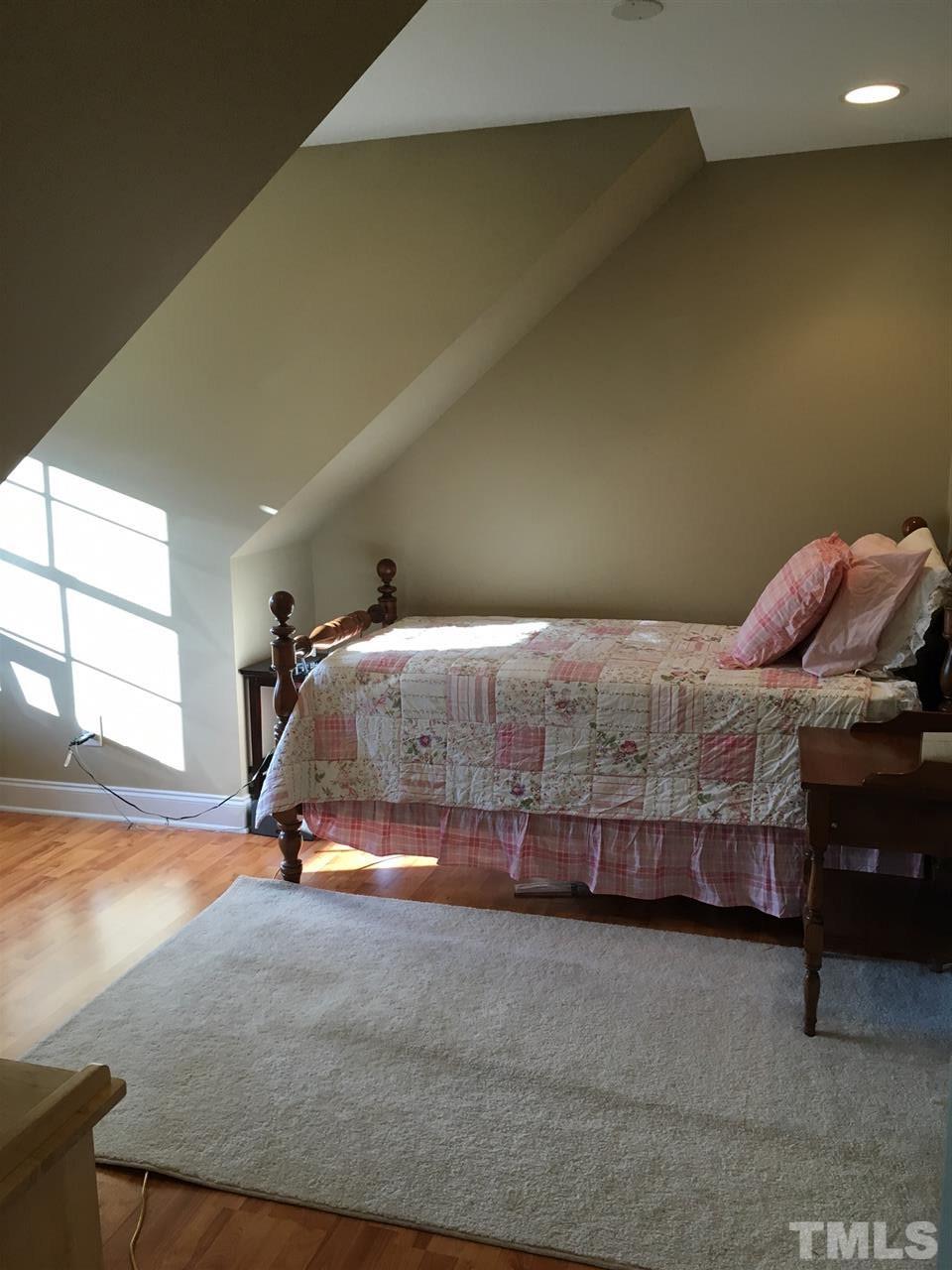 8114 Dreamy Way Raleigh, NC 27613 - Photo 18 of 22 a bedroom with a bed and a window