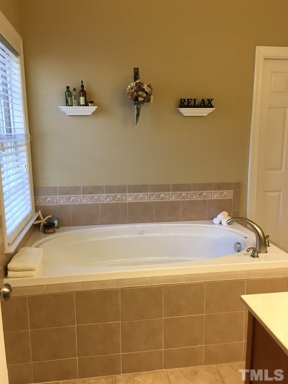 8114 Dreamy Way Raleigh, NC 27613 - Photo 19 of 22 a bathroom with a bathtub