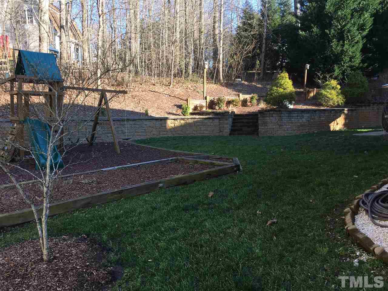 8114 Dreamy Way Raleigh, NC 27613 - Photo 21 of 22 a view of backyard with seating area and trees