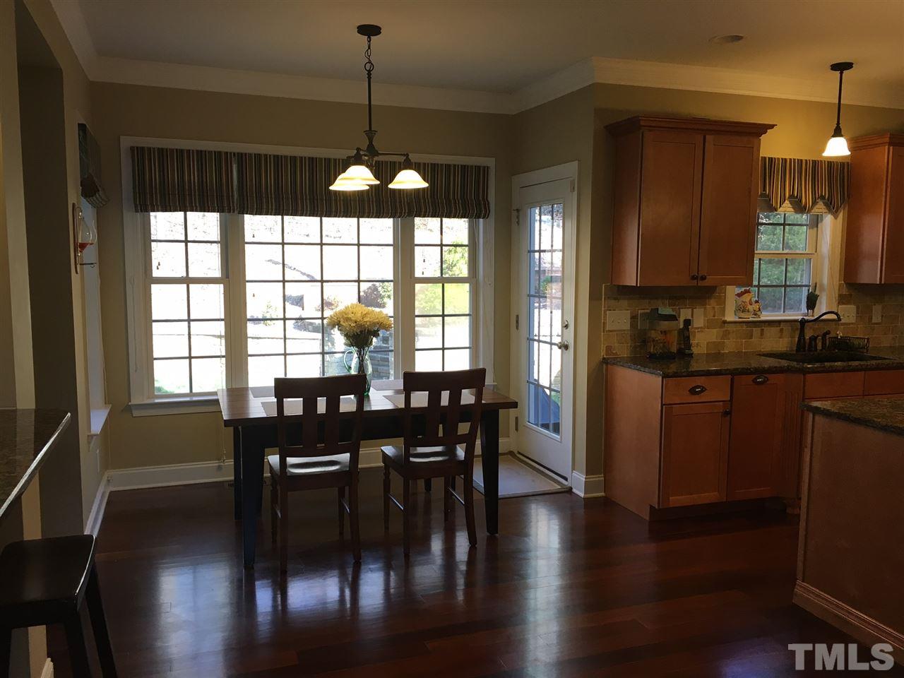 8114 Dreamy Way Raleigh, NC 27613 - Photo 5 of 22 a view of a dining room with furniture window and wooden floor